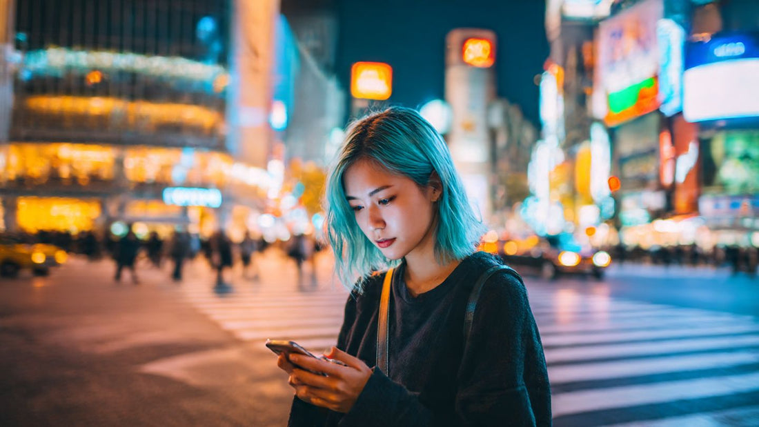 traveler_using_a_smartphone_in_shibuya_crossing_1_3ef350a811.jpeg