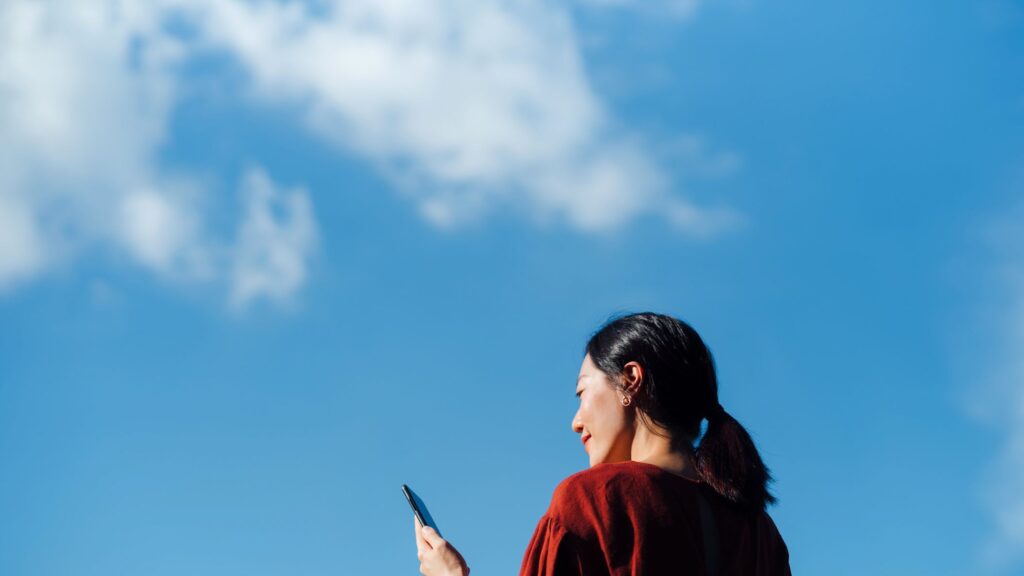 Traveler celebrating instant connectivity using Global eSIM.