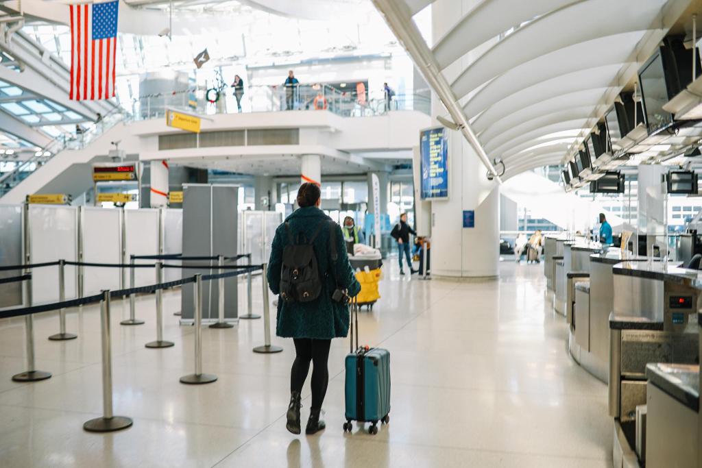 Traveler booking a ride using mobile app in the USA with fast internet connection