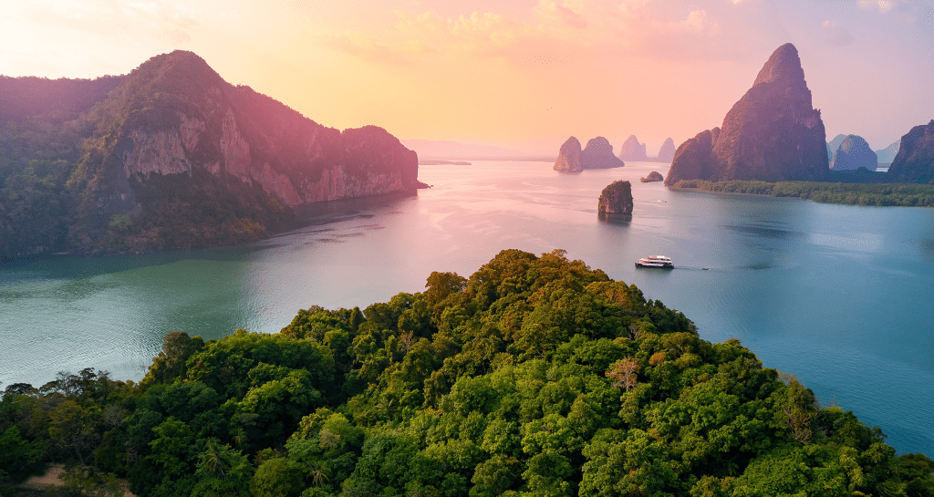 Phuket beach with tourists enjoying tropical coastline in Thailand