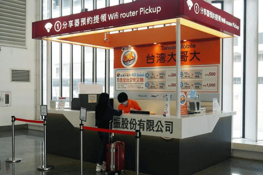 Travelers struggling at airport kiosks comparing china hong kong esim vs pocket wifi and local sim options