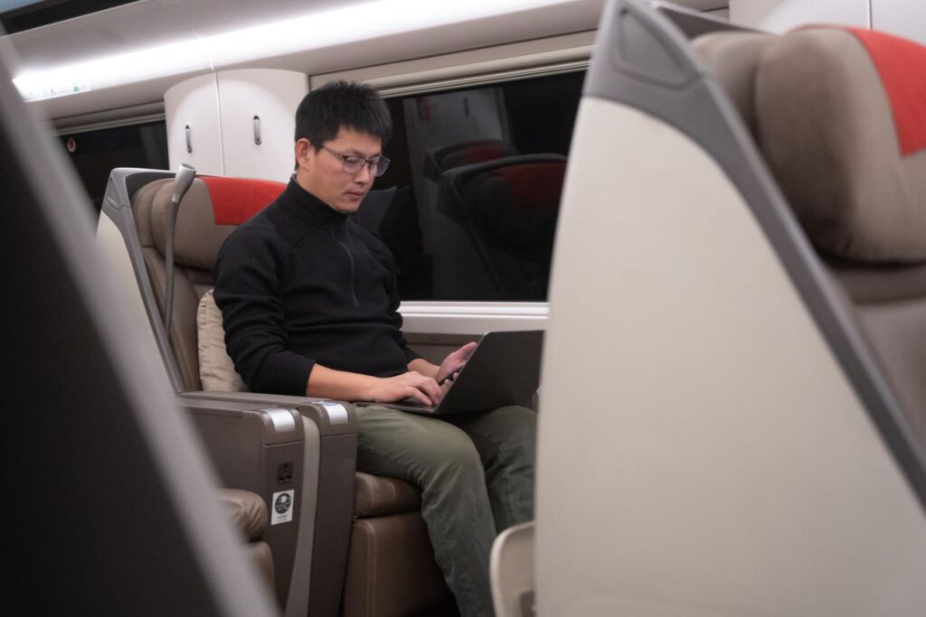 Executive managing emails on the go using business travel china hong kong esim connection