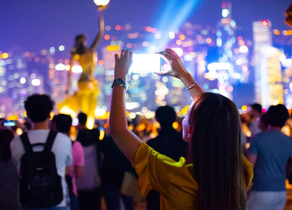 Confident traveler using china hong kong travel apps with reliable esim connection

