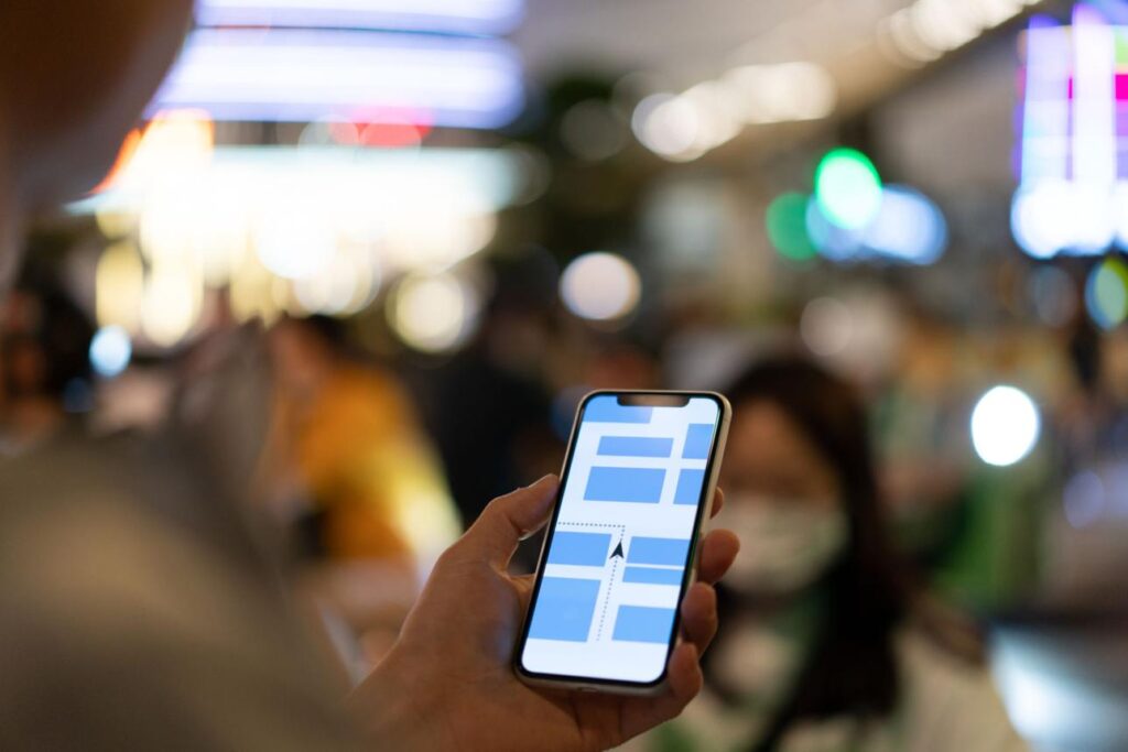 Traveler navigating city using china hong kong travel apps maps in busy street
