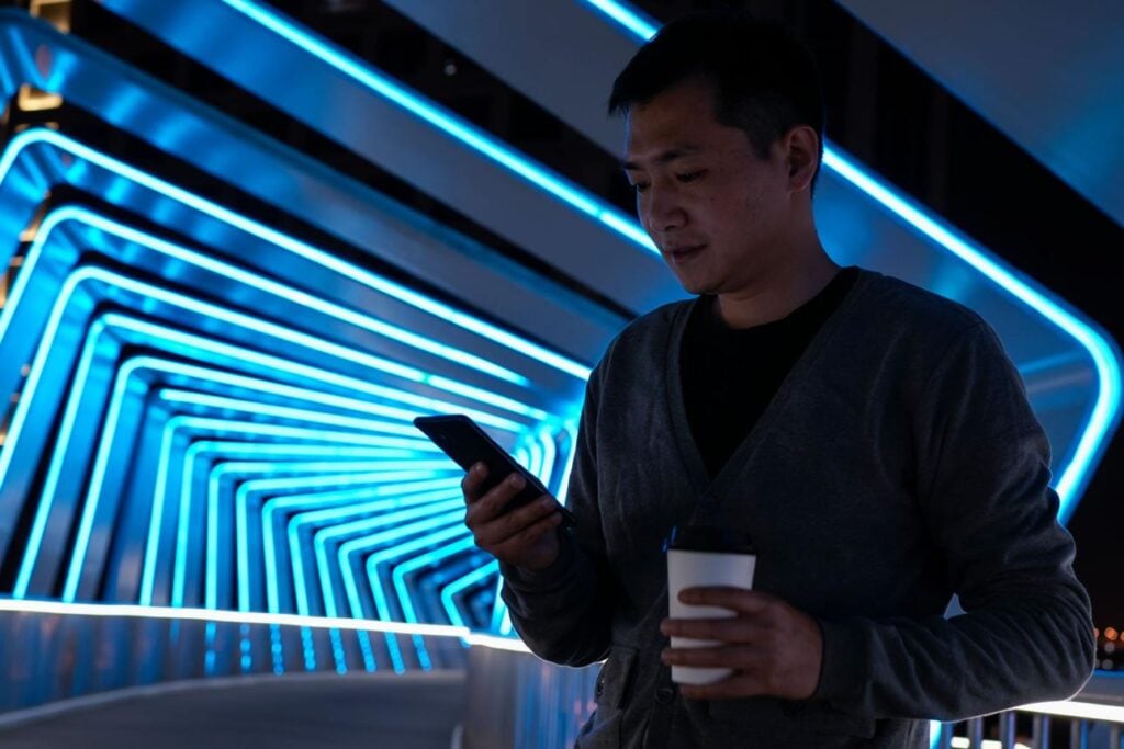 Traveler using smartphone apps in city showing importance of china hong kong travel apps connectivity